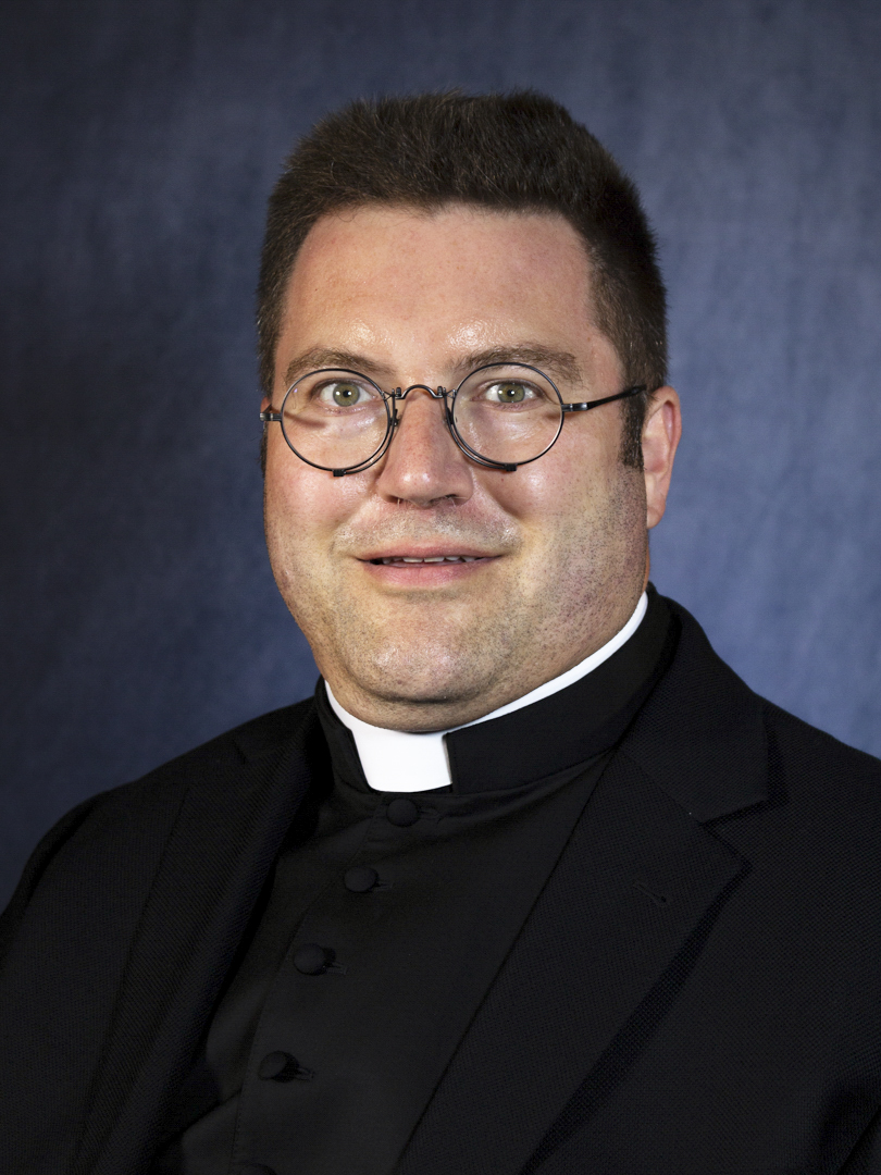 priest with glasses