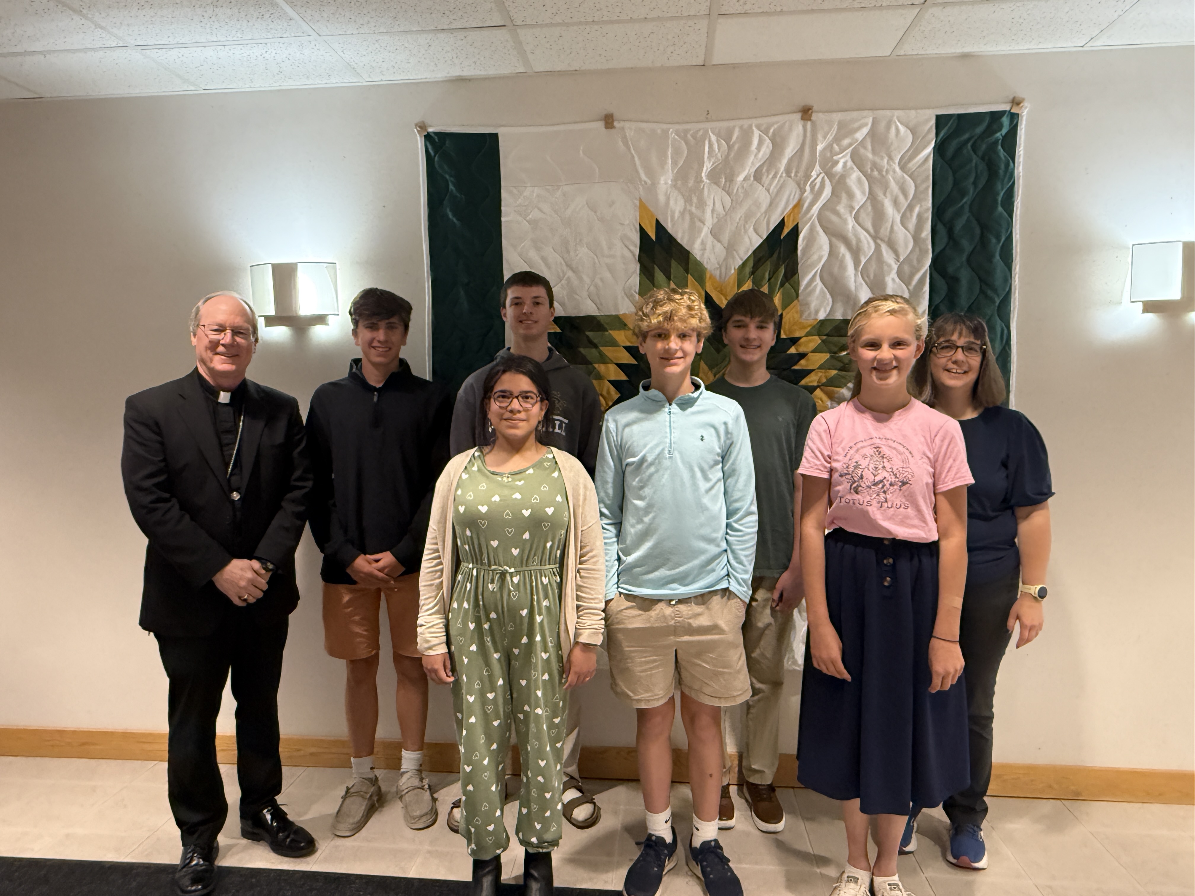 group of kids with bishop and adult
