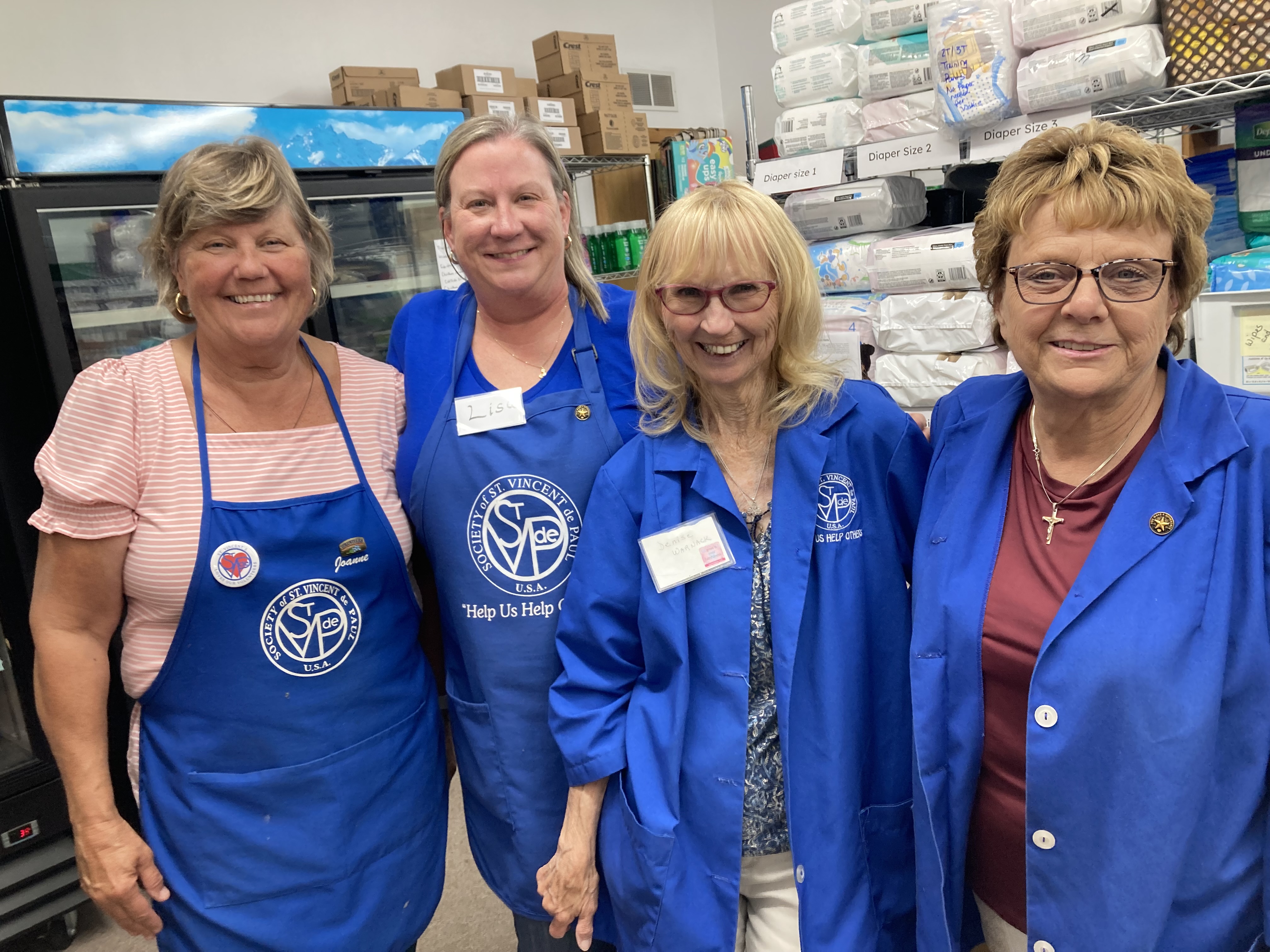 four women volunteering at St. Vincent de Paul Society food pantry.