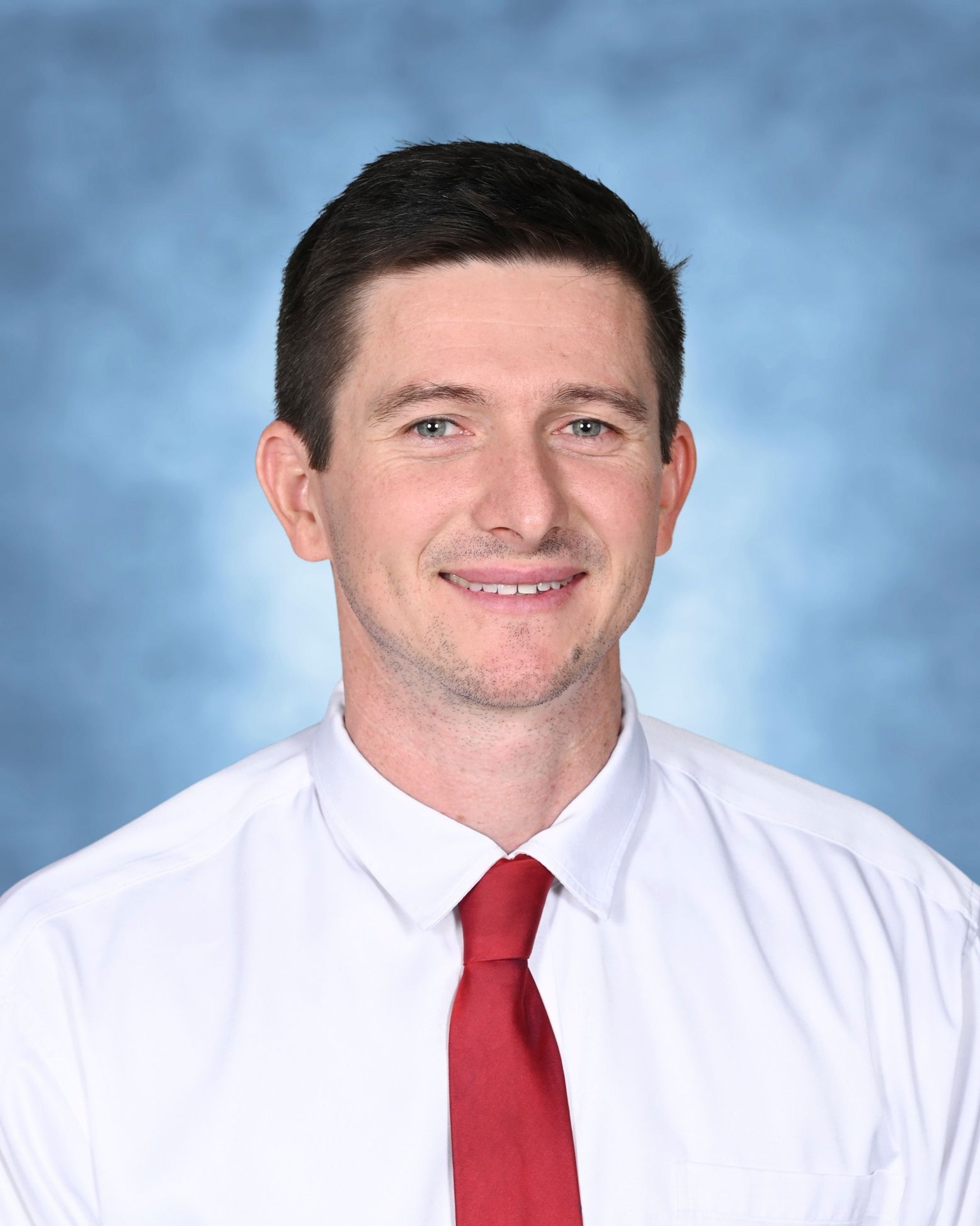 man in white shirt and red tie
