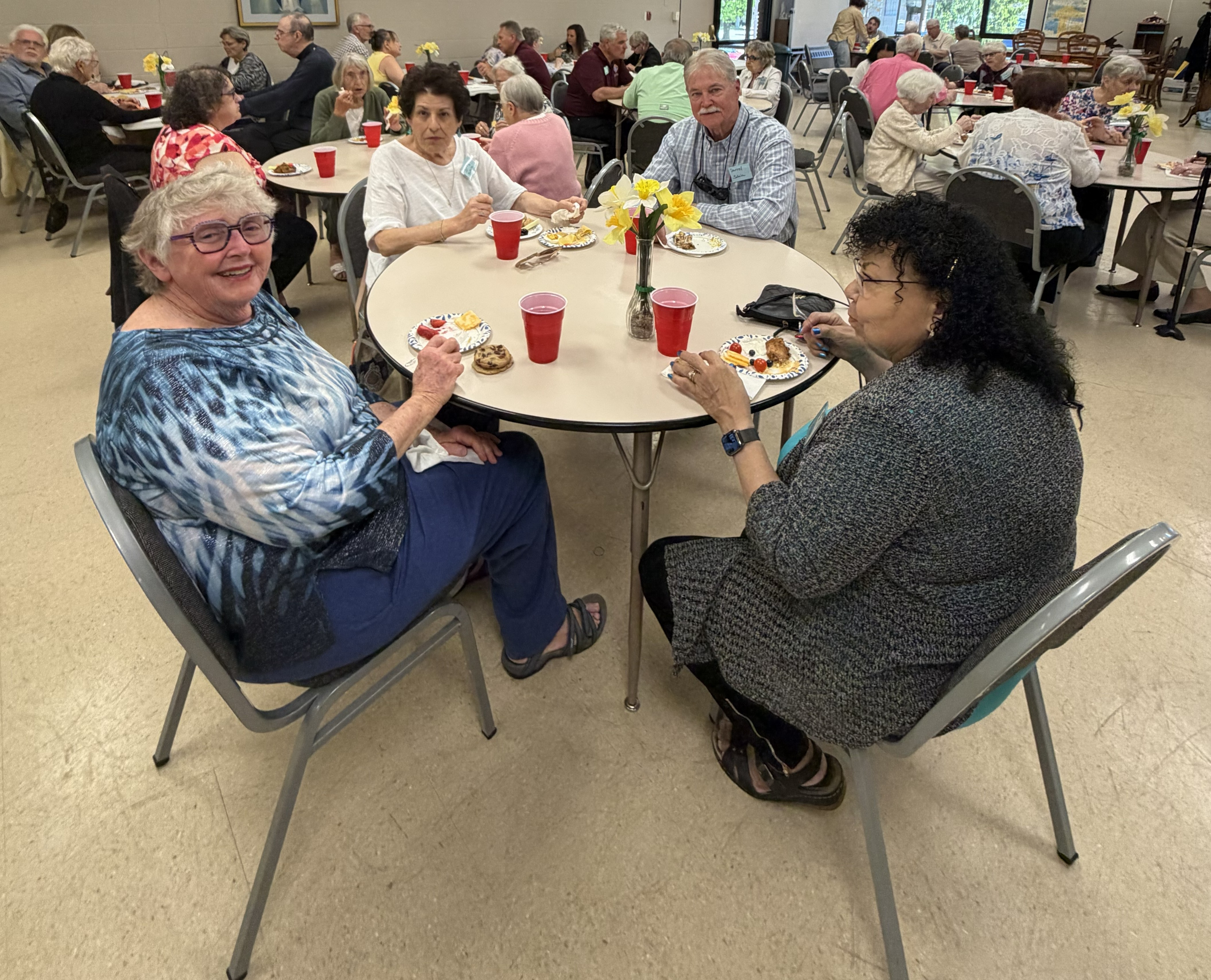 group of older people sitting at a table