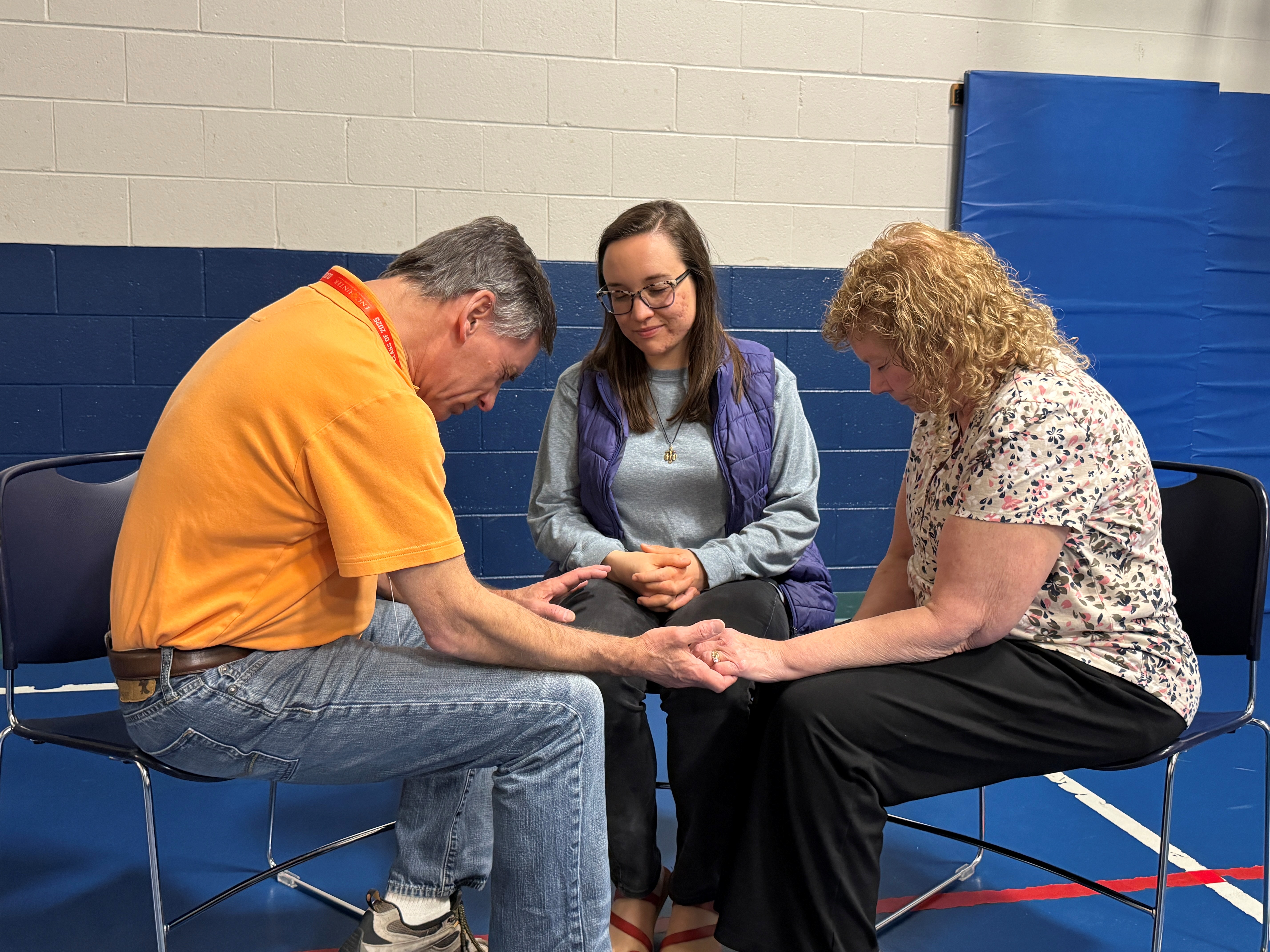 Mark and Ann-Laurie praying with young woman