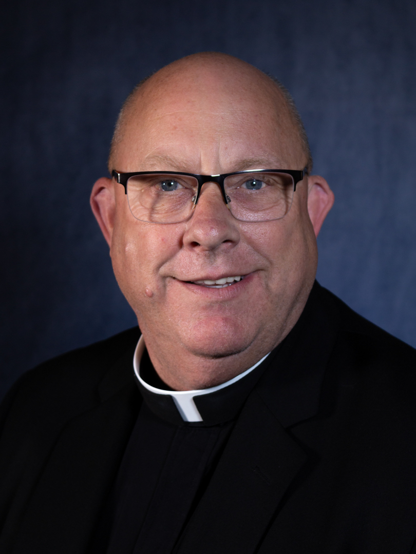 Fr. James Siler, bald man in priest garb