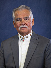 gray haired man with mustache headshot