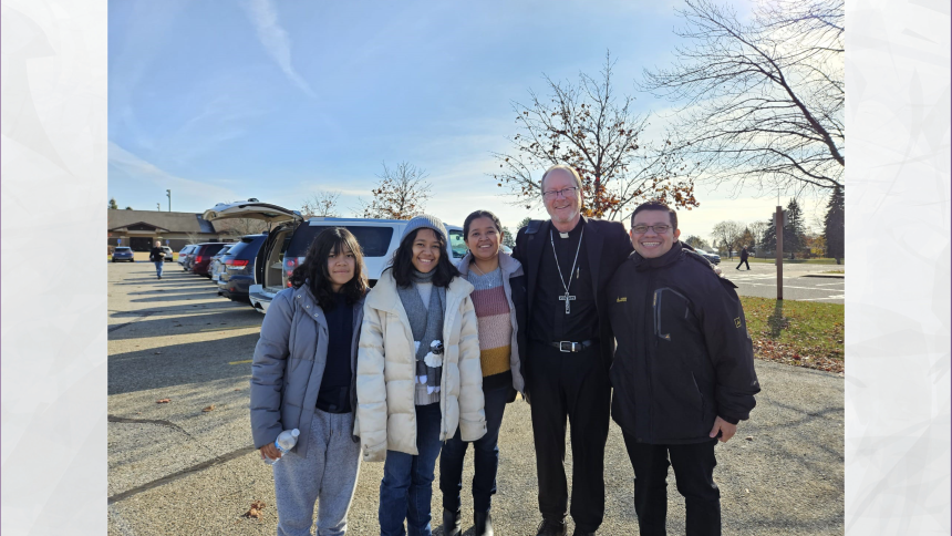 Hazzel, Bishop Walsh and her family standing in a parking lot