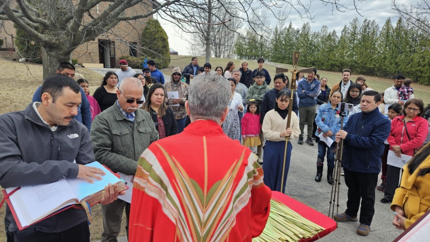 priest with parishioners outside