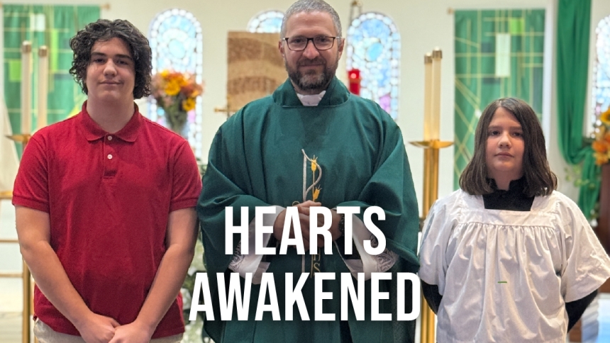 middle school boys standing with priest