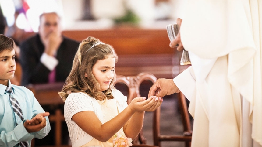 girl receiving first communion