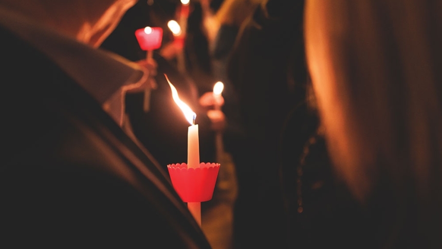 people holding candles during Easter Mass