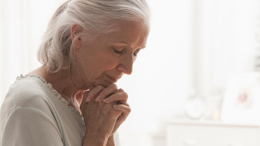 older woman praying