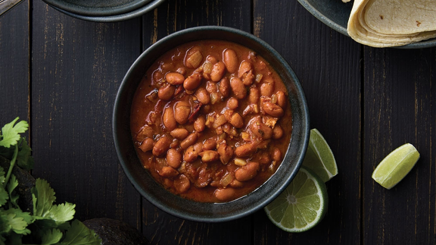 bowl of beans with slices of limes