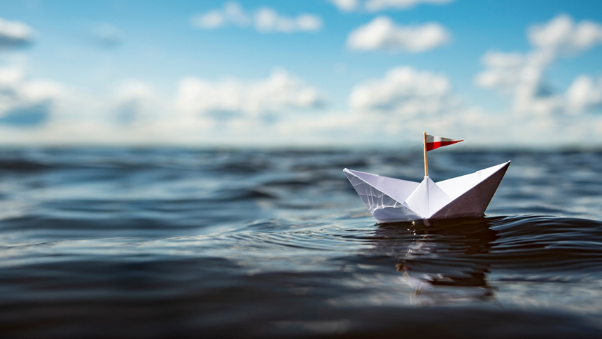 paper boat floating in water
