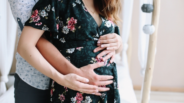 pregnant couple hugging