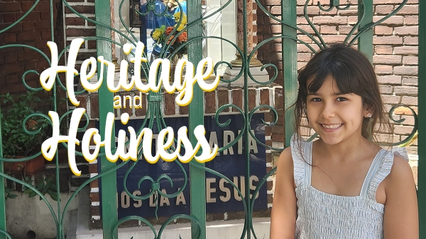 young girl standing in front of gated shrine
